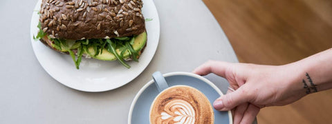 coffee and sandwich being served at a cafe