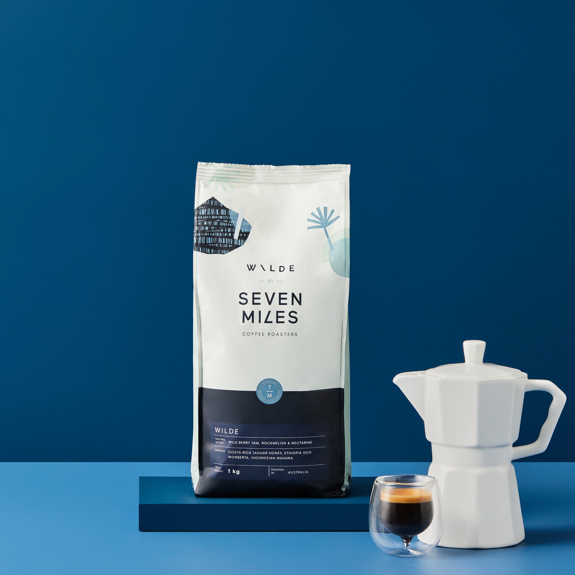 Seven Miles Coffee Roasters Wilde blend 1kg on a table next to a mokka pot and a glass cup with an espresso shot.