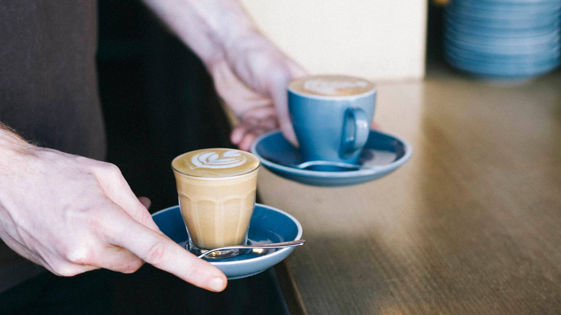 Barista delivering Bills Beans Coffees to table