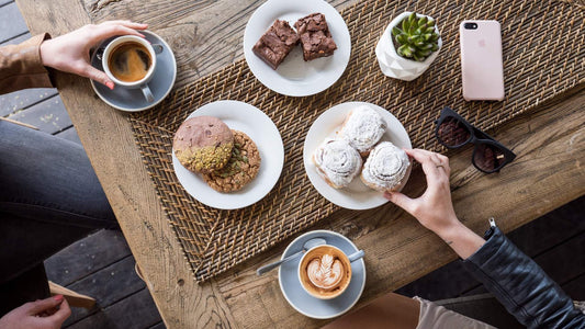 coffee and pastries on table in cafe