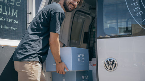 seven miles cafe support team unloading boxes of coffee