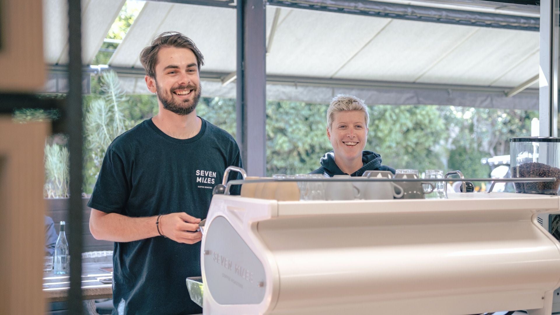 baristas making coffee on a commercial espresso machine