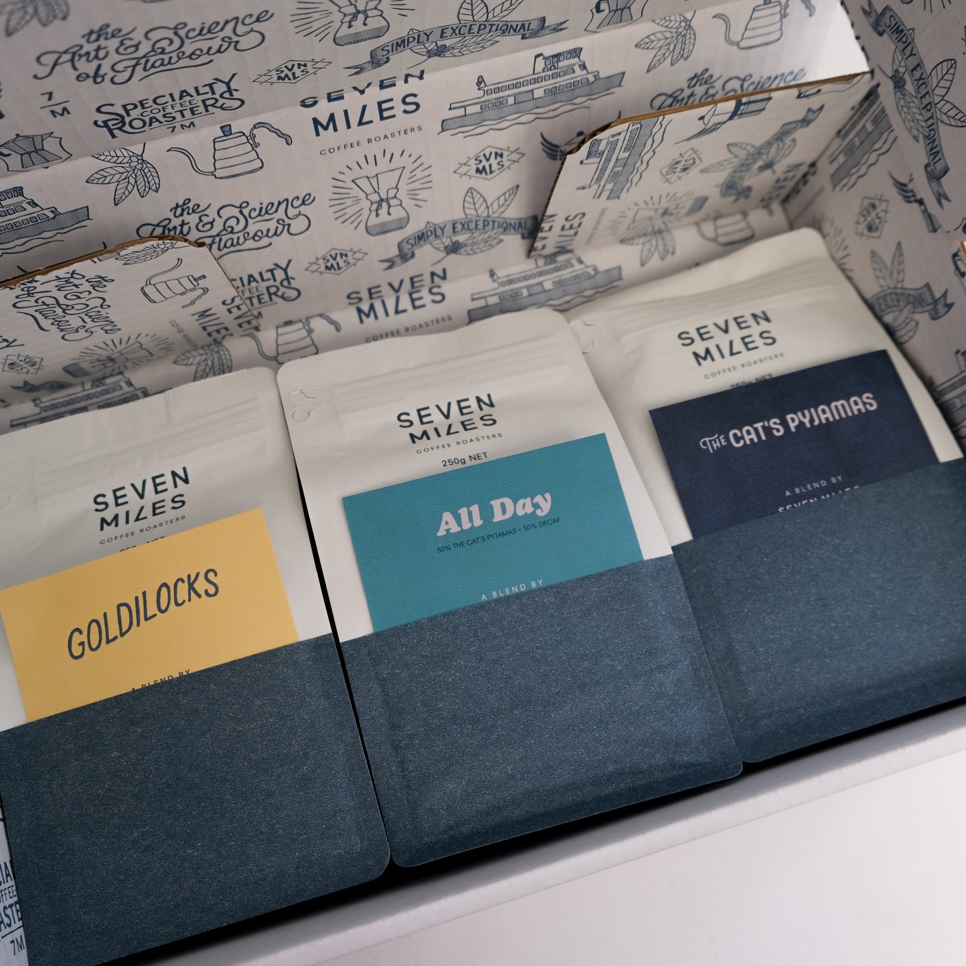 250g bags of each: Goldilocks coffee blend, All Day Half Caff blend, and The Cat's Pyjamas coffee blend in a box.