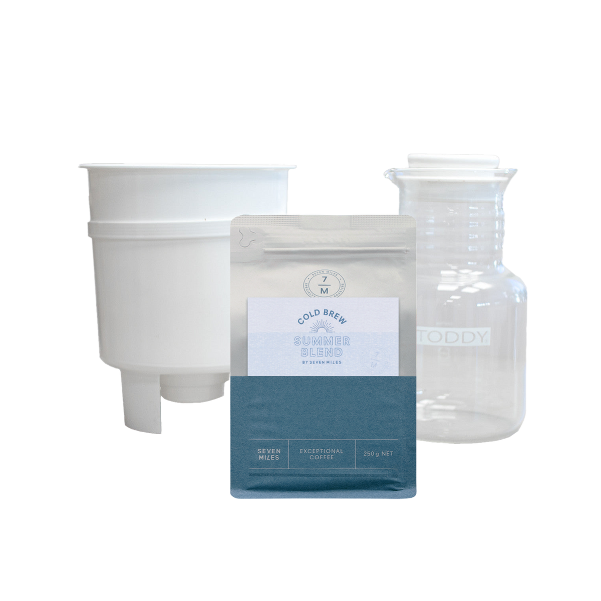 A product bundle featuring a white plastic funnel, a clear glass decanter with 'TODDY' printed on it, and a silver and teal pouch of 'Gold Reef' Coffee Roaster Blend.