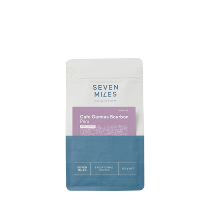 Packaging for Seven Miles Peru Cafe Garmas Bourbon coffee, featuring product name and description, with a blue and white color scheme.